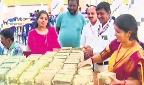 Sri Chamundeshwari temple staff with the hundi collection | Express
