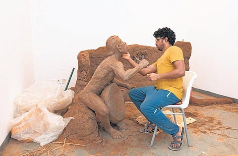 Artist Ashis Kumar Palei gives finishing touches to a piece of art
