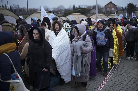 Refugees wait in a crowd for transportation after fleeing from the Ukraine and arriving at the border crossing in Medyka, Poland, Monday, March 7, 2022. (File Photo | AP)