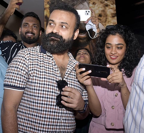 Kunchacko Boban and Gayathri Shanker coming out after the first show of Nna Thaan case Kodu Movie at Padma theatre in MG Road. (Express Photo | A Sanesh)