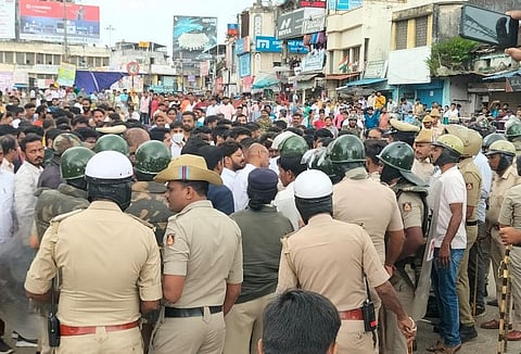 The mob arguing with the police at Amir Ahmed Circle in Shivamogga on Monday. (Photo | EPS)
