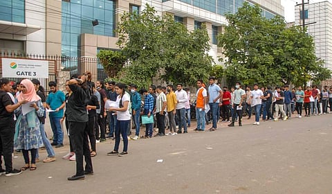 Students wait in a queue to appear in Common University Entrance Test (CUET), outside a centre, in Noida, Wednesday, Aug 17, 2022.  (Photo | PTI)