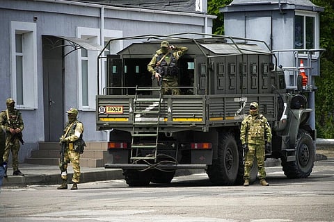 Russian soldiers guard an area as a group of foreign journalists visit in Kherson, Kherson region, south Ukraine, May 20, 2022.(File photo | AP)
