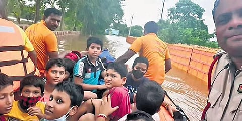 Stranded students being rescued by fire and ODRAF personnel