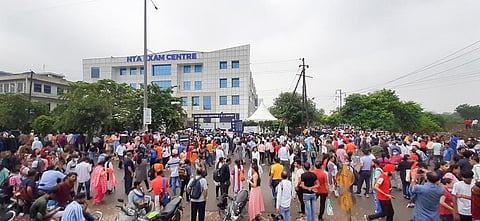 Students gather outside an exam centre after the National Testing Agency (NTA) cancelled second shift of the Common University Entrance Test undergraduate (CUET UG) 2022. (Photo | PTI)