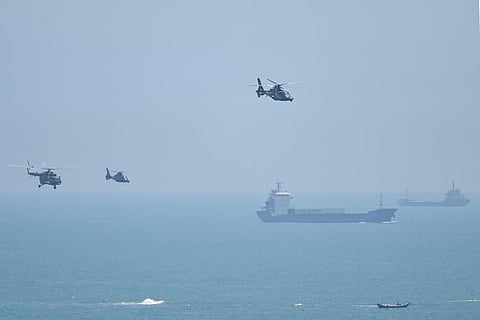 Chinese military helicopters fly past Pingtan island, one of mainland China's closest point from Taiwan, in Fujian province on August 4, 2022. (Photo |AFP)