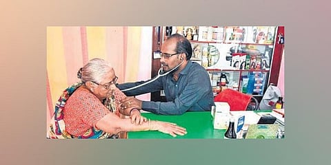 Badari Narayana attends to one of his patients at his clinic. (Photo | Madhav K, EPS)