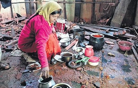Shankaravva collects utensils from the remains of her house