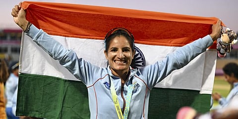 Indian women's cricket team player Renuka Singh holds a tricolor after the medal ceremony at the Commonwealth Games 2022.(Photo | PTI)