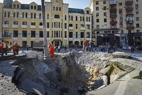 A view of a crater from a night Russian rocket attack, near to damaged buildings in downtown Kharkiv, Ukraine, Saturday. (Photo | AP)