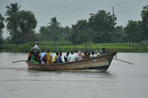 Residents of Pamulanka commuting through country boats as the road leading to the village was inundated in Krishna district on Saturday | Prasant Madugula