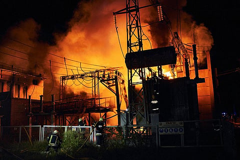 Ukrainian State Emergency Service firefighters put out the fire after a Russian rocket attack hit an electric power station in Kharkiv, Ukraine. (Photo | AP)