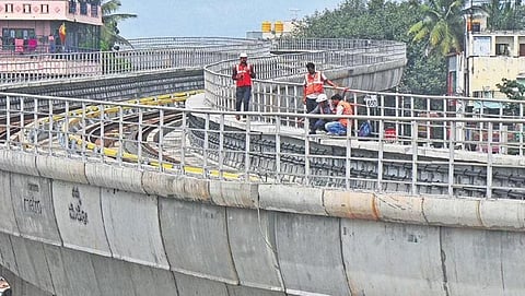 Workers carry out repair works along the tracks between Mysuru Road and Kengeri Metro Stations on Thursday | Vinod Kumar T