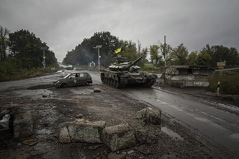 Ukrainian tank drives past former Russian checkpoint (Photo | AP)
