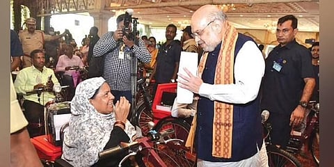 Union Home Minister Amit Shah with a beneficiary in Hyderabad on Saturday