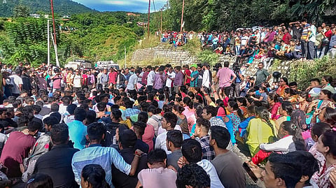 Protestors block the Rishikesh-Badrinath national highway in Uttarakhand's Srinagar area on Sunday over the death of 19-year-old receptionist Ankita Bhandari. (Photo | PTI)