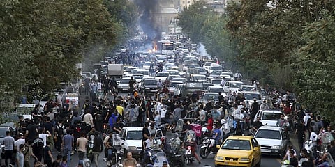 Protesters chant slogans during a protest over the death of Mahsa Amini who was detained by the morality police, in downtown Tehran, Iran.(Photo | AP)