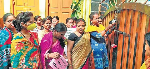 Guardians locking the gate of Lady Lewis Girls’ High School on Thursday | Express