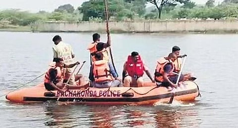 Police and DRF personnel search for the bodies of two students at Cheeryal lake at Keesara near Hyderabad on Thursday