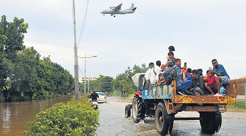 Desperate citizens ride a tractor on a flooded road in Mahadevapura, which has  been rain-hit, in Bengaluru on Tuesday | Vinod Kumar T