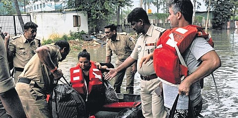 Fire personnel rescue expats Daniel and Premika from their villa in Bengaluru on Wednesday |  Vinod Kumar T