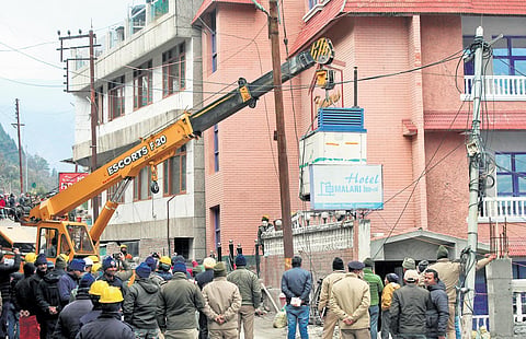 A crane takes out heavy equipment from the unsafe Hotel Malari Inn in Joshimath  town as part of the demolition process that began on Thursday | PTI