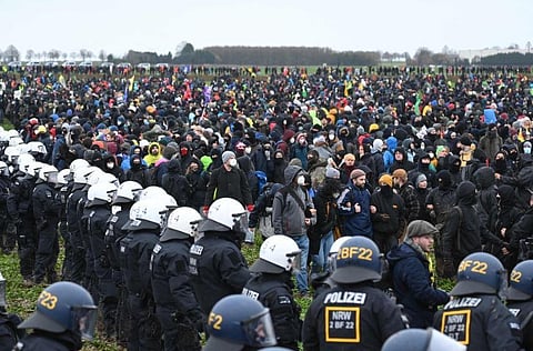 Police face protesters during a large-scale protest to stop the demolition of the village Luetzerath to make way for an open-air coal mine extension on January 14, 2023. (Photo | AFP)