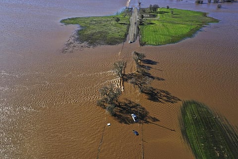 Three vehicles are submerged on Dillard Road west of Highway 99 in south Sacramento County in Wilton, California on January 1, 2023, after heavy rains on New Year's Eve produced levee breaks | AP