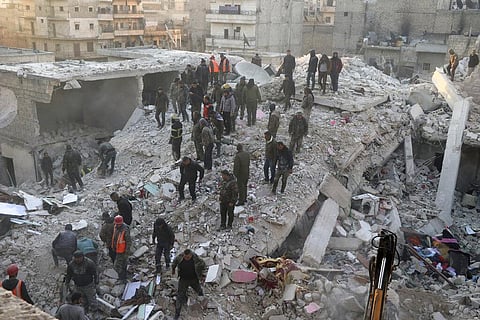 Civil defense workers and civilians work on the rubble of a destroyed building in the Sheikh Maksoud neighborhood in Aleppo, Syria |AP