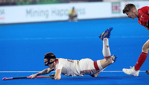 English field hockey player Sam Ward in action