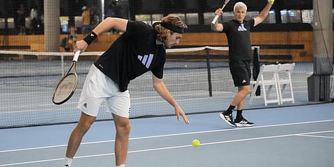 Stefanos Tsitsipas of Greece serves as his father and coach, Apostolos, right, watches during a practice session ahead of the men's final at the Australian Open.(Photo | AP)
