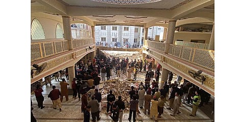Security officials inspect the site of a mosque blast inside the police headquarters in Peshawar on January 30, 2023. (Photo | AFP)