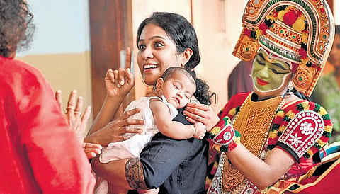 Smitha Therese Joy, who had participated in the State School Kalolsavam of 2004, interacting with her former Ottamthullal guru when she arrived at the Kalolsavam venue with her two-month-old toddler.