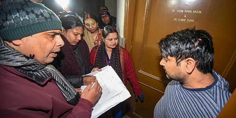 Enumerator staff receive information from residents during the first phase of much-hyped caste-based census in Bihar. (Photo | PTI)