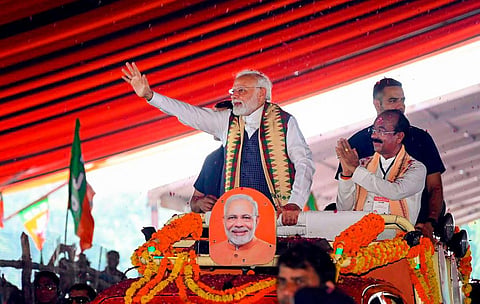 PM Narendra Modi with Chhattisgarh BJP President Arun Sao waves at supporters as he arrives for the 'Parivartan Mahasankalp' rally, in Bilaspur, Saturday, Sept. 30, 2023. (Photo | PTI) 