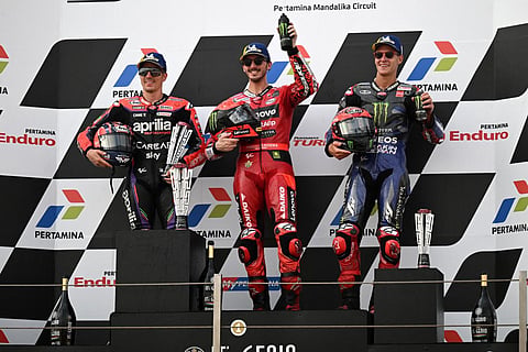 Ducati's Francesco Bagnaia (C), Aprilia’s Maverick Vinales (L), and Yamaha's Fabio Quartararo celebrate during the podium ceremony in the Indonesian GP, Oct 15, 2023. (Photo | AFP)