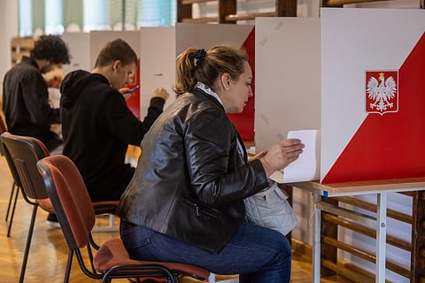 People vote at a polling station in Warsaw during the parliamentary elections on October 15, 2023. (Photo | AFP)