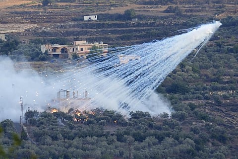A shell from Israeli artillery explodes over a house in al-Bustan, a Lebanese border village with Israel, south Lebanon, Sunday, Oct. 15, 2023.
