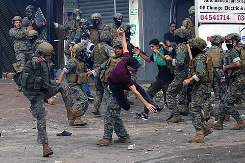 Lebanese soldiers scuffle with protesters during a demonstration, in solidarity with the Palestinian people in Gaza, near US Embassy in Aukar, a northern suburb of Beirut, Lebanon, on Oct 18. (AP)
