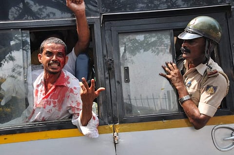 (Representational Image) A bloodied PFI activist being taken away by police after Popular Front of India members clashed with police over arrest of fellow member, Sept 2022. (Photo | EPS)