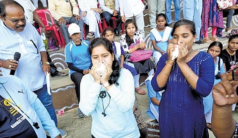 Girls blowing conch during the competition at Berhampur | Express