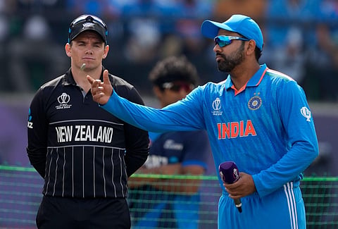 New Zealand's captain Tom Latham watches as India's captain Rohit Sharma spins the coin at the toss. (Photo | AP)