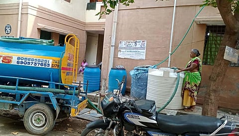 Residents in TNUHDB at Keerthanam purchase water for house hold usage from private operator due to no water supply for the last two weeks.(Photo | Express)
