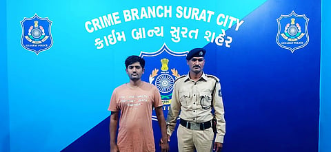 Bangladeshi national Abu Bakar alias Alim Haq with an officer of the Surat crime branch. (Photo | Special arrangement)