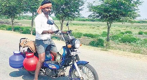 Devappa Korlagundi carries  water pots on his motorcycle to  his farm at Yarehanchini village  in Koppal district | EXPRESS
