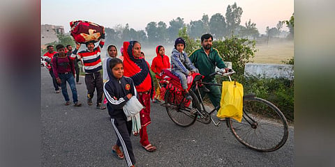 Villagers shift to a safer place following unprovoked firing by the Pakistan Rangers along the international border, in Arnia area of Jammu district. (Photo | PTI)