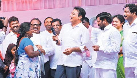 MA&UD Minister KT Rama Rao shares a light moment with a beneficiary  while distributing 2BHK sanction letters in Suryapet on Monday.