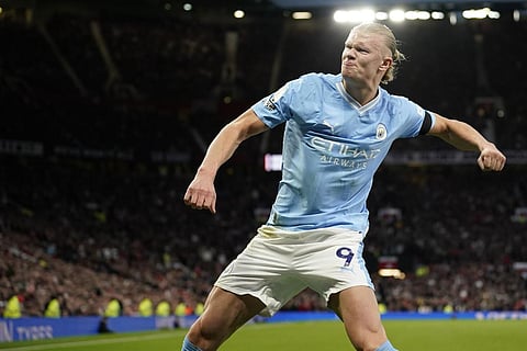 Manchester City's Erling Haaland celebrates after scoring his side's opening goal from a penalty kick during the EPL soccer match between Manchester United and Manchester City. (Photo | AP)
