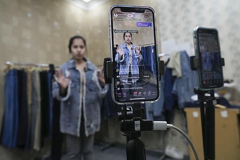 A seller offers merchandise using live streaming at a store in the Tanah Abang textile market in Jakarta, Indonesia on Wednesday (Photo | AP)