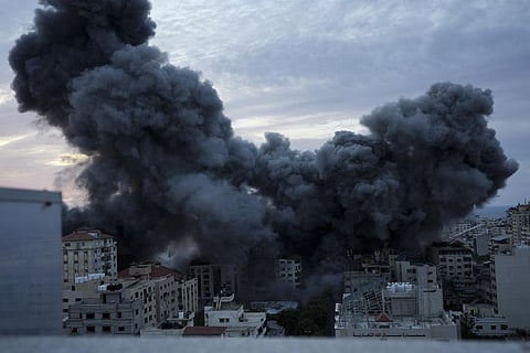 Smoke rises from an explosion on a Palestinian apartment tower following an Israeli air strike in Gaza City.
